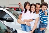 image of family  - Family holding keys to their new car at the dealer - JPG 