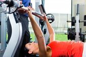 picture of health  - Woman with her personal fitness trainer in the gym exercising with dumbbells - JPG 