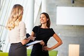 picture of meeting  - Two Businesswomen Having Informal Meeting In Modern Office - JPG 