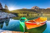 stock photo of black  - Reflection in water of mountain lakes and boats - JPG 