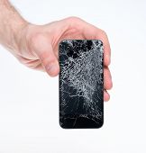 image of objects  - Studio closeup of a male hand holding an apple iphone with a cracked screen isolated on a white background - JPG 