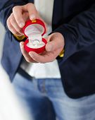 pic of present  - Engagement ring or present in the hands of a man in suit
 - JPG 
