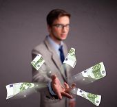 picture of money  - Handsome young man standing and throwing money - JPG 
