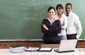 stock photo of teach  - three teaching staff posing in a classroom in front of a blackboard - JPG 
