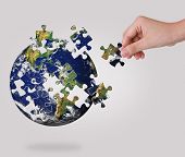 picture of globe  - Business concept with a hand building puzzle globe - JPG 