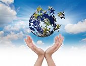 picture of puzzle  - Business concept with a hand building puzzle globe - JPG 