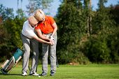 foto of golfer  - senior couple playing golf on a summer afternoon - JPG 