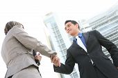 picture of business people  - Attractive man and woman business team shaking hands - JPG 