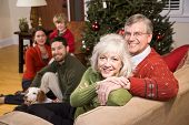 image of family  - Senior couple with family by Christmas tree  - JPG 