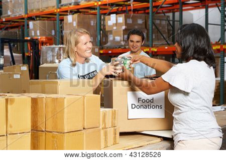 Picture or Photo of Volunteers Collecting Food Donations In Warehouse