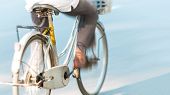stock photo of transportation  - Focus on old white bicycle from behind - JPG 