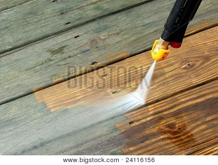 Picture or Photo of A pressure washer cleaning a wood deck