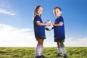 pic of youth  - Youth Soccer players smiling together on a grass field - JPG 