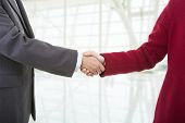 image of handshake  - business couple shaking hands at the office - JPG 