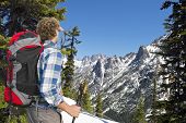 image of pass  - Hiker admiring the view on the snowy mountains of the Kangaroo ridge from the Washington Pass overlook in the North Cascades Range - JPG 