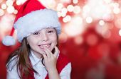 stock photo of curiosity  - Smiling girl in santa hat - JPG 