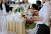 pic of food  - Waitress is carrying three plates with meat dish - JPG 