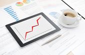 image of desktop  - Desktop with success business report on a modern apple ipad  some papers with charts and graphs and with a cup of coffee - JPG 