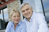 picture of cheerful  - Cheerful senior couple looking at camera - JPG 