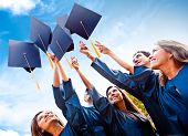 image of group  - Students throwing graduation hats in the air celebrating - JPG 