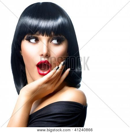 Picture or Photo of Beauty Surprised Brunette Woman isolated on White background. Beautiful Girl opening Mouth. Emotion. Red Lips and Black Nails. Hairstyle. Makeup