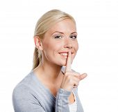 stock photo of quiet  - Female making silence gesture with forefinger - JPG 
