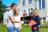 picture of agent  - Happy family with agent realtor near new house - JPG 