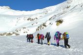 stock photo of team  - Team of alpinists traversing an iced lake in National Park Retezat - JPG 