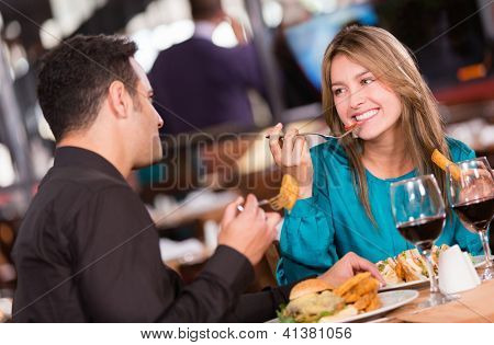 Picture or Photo of Friends eating at a restaurant  and looking happy