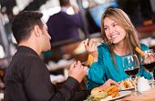 pic of food  - Friends eating at a restaurant  and looking happy - JPG 