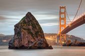 stock photo of golden gate bridge  - The Golden Gate Bridge and a weathered rock in the San Francisco Bay - JPG 