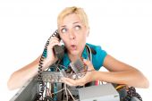 foto of computer technology  - confused woman phoning technology support for computer - JPG 