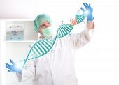 picture of future technology  - Researcher or a medic holding up a DNA strand - JPG 