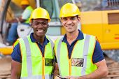 stock photo of construction  - two cheerful male road construction workers on construction site - JPG 