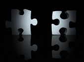 pic of business concept  - 3d puzzle pieces with a metallic texture over black - JPG 