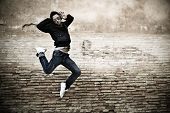 stock photo of man  - Young attractive man dancing in urban background - JPG 