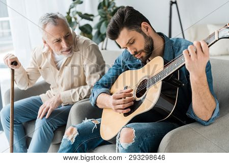 Poster: Handsome Bearded Man Playing Acoustic