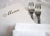 foto of restaurant  - menu with forks on white table cloth - JPG 
