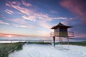 picture of hut  - lifeguard hut on australian beach at sunrise with interesting clouds in background  - JPG 