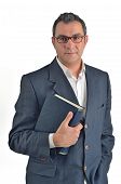stock photo of businessmen  - Businessman holding a book isolated on white background - JPG 