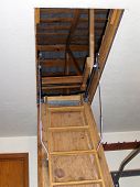 stock photo of pulldown  - pull down stair leading up to a dark attic space - JPG 
