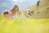 pic of dog  - Happy family walking with dog in green field - JPG 