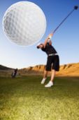 picture of golf  - A golfer driving the ball down the fairway focus on the ball - JPG 