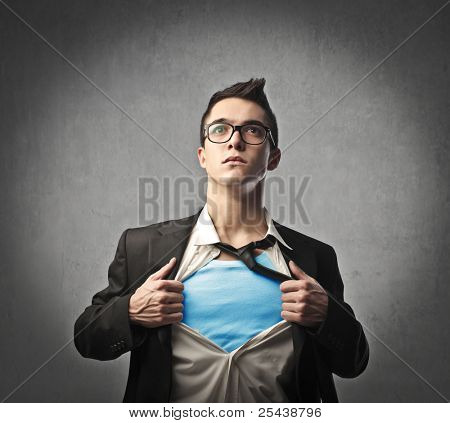 Picture or Photo of Businessman showing a superhero suit underneath his suit