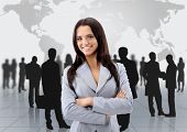 stock photo of team  - Happy young business woman standing in front of her team - JPG 
