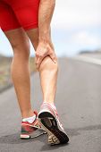 image of fitness  - Cramps in leg calves or sprain calf on triathlete runner - JPG 