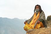 foto of religion  - Indian old monk sadhu in saffron color clothing - JPG 