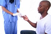 picture of bloodpressure  - african american nurse and patient checking blood sugar - JPG 