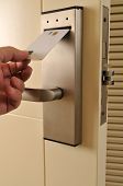 pic of locking  - A hand inserting keycard in the electronic lock  - JPG 