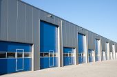stock photo of industrial  - Silver industrial unit with roller shutter doors - JPG 
